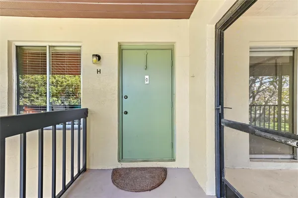 a view of a porch with a floor to ceiling window