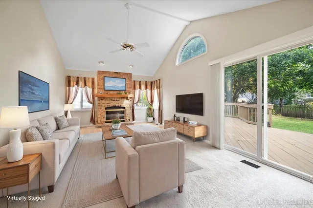 a living room with furniture a flat screen tv and a fireplace