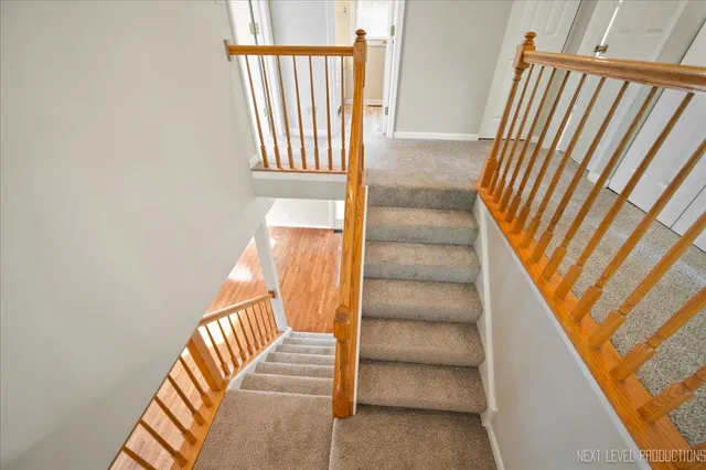 a view of staircase with white walls and a window