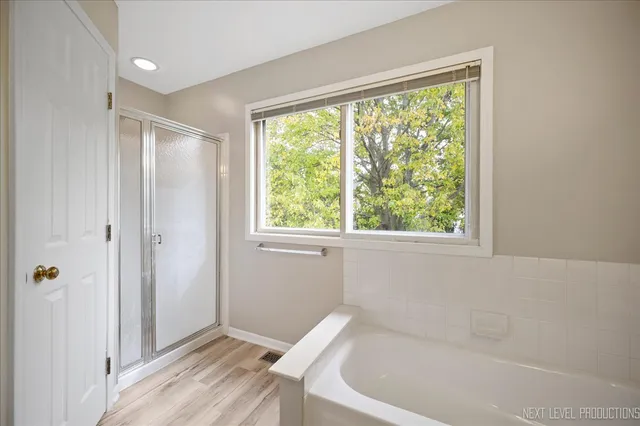 a bathroom with a bathtub and shower