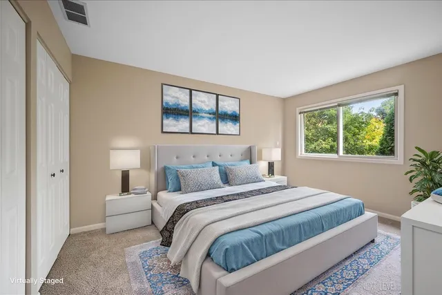 a bedroom with a large bed and a window