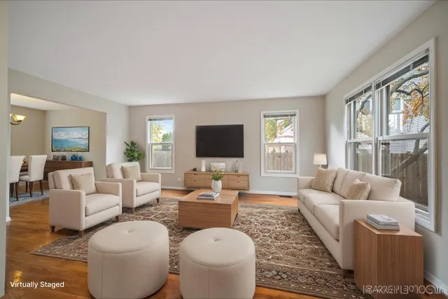 a living room with furniture a flat screen tv and a large window