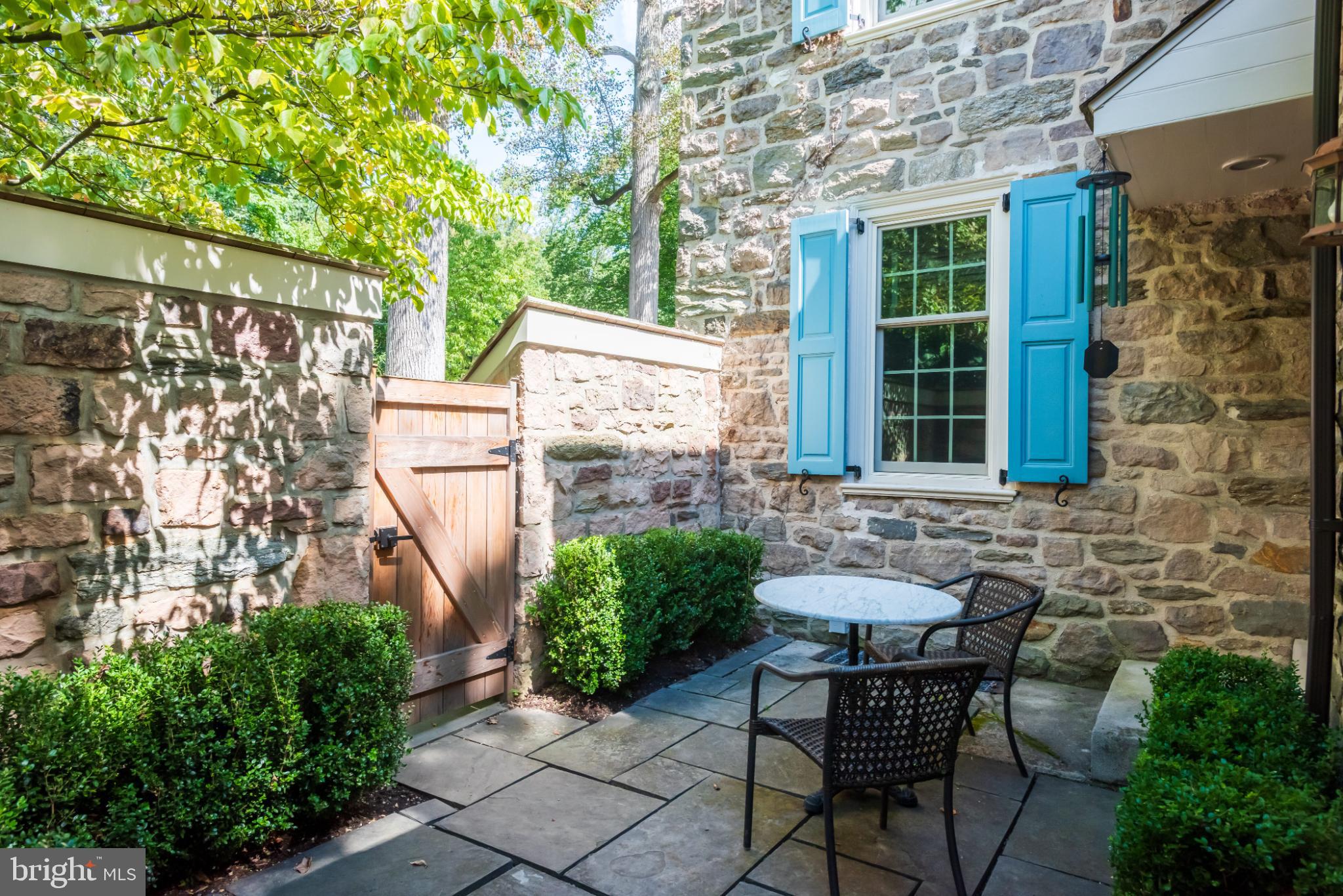 315 Caversham Road Bryn Mawr, PA 19010 - Photo 45 of 55 Charming stone patio with vibrant greenery.