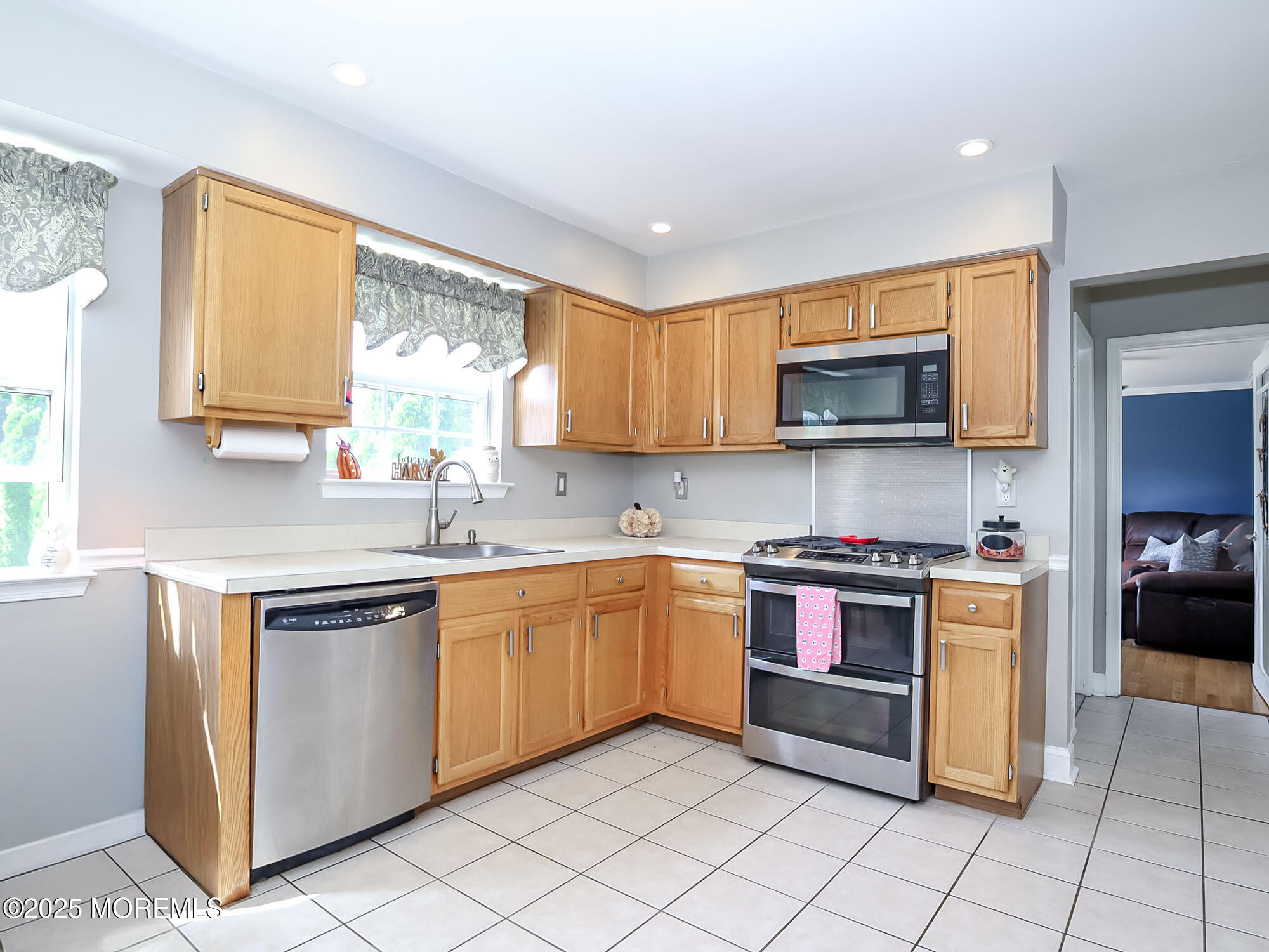 22 Abraham Drive Howell, NJ 07731 - Photo 11 of 24 a kitchen with stainless steel appliances granite countertop a stove top oven a sink dishwasher and a microwave oven on the blue kitchen countertops