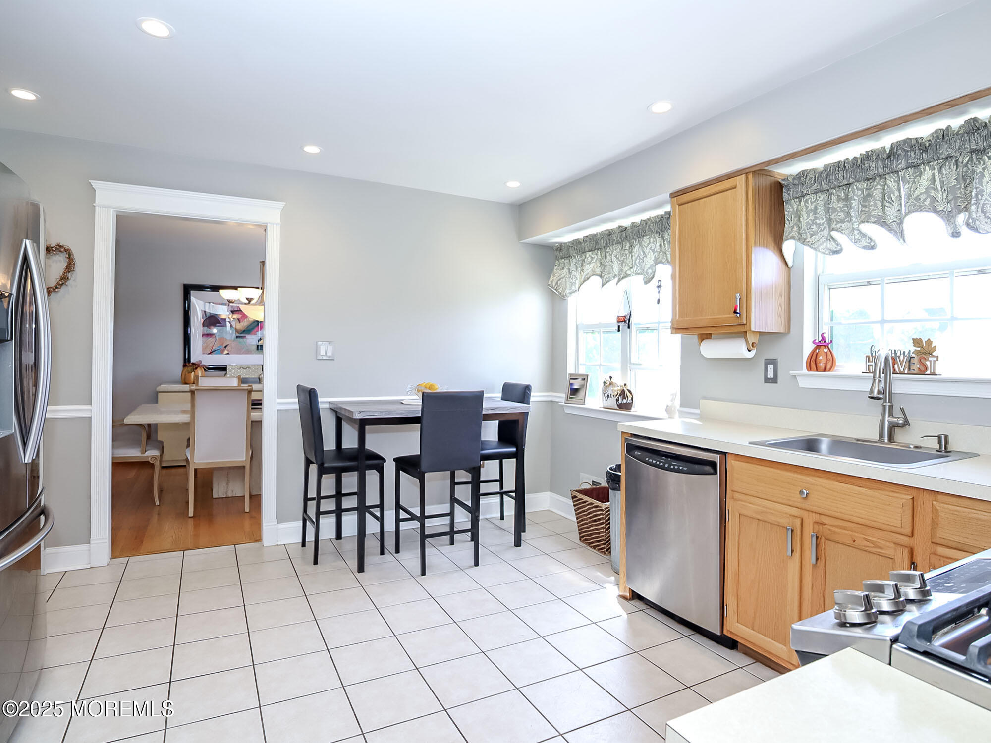 22 Abraham Drive Howell, NJ 07731 - Photo 12 of 24 a large dining hall with stainless steel appliances a sink table and chairs