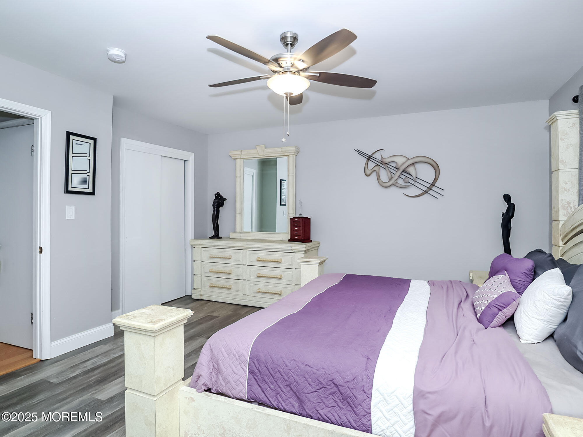 22 Abraham Drive Howell, NJ 07731 - Photo 17 of 24 a bedroom with a large bed and a chandelier