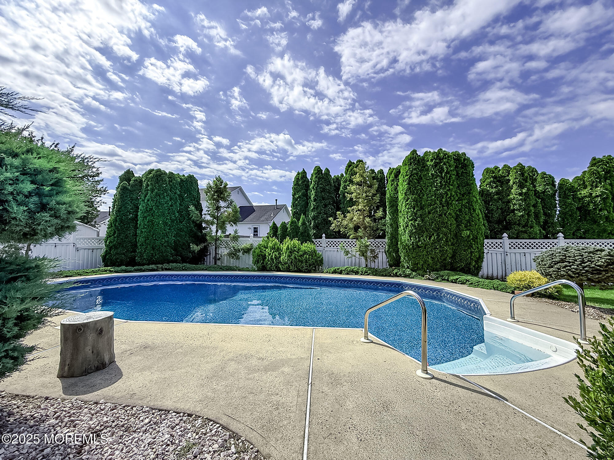 22 Abraham Drive Howell, NJ 07731 - Photo 4 of 24 a view of swimming pool with seating space and trees in the background