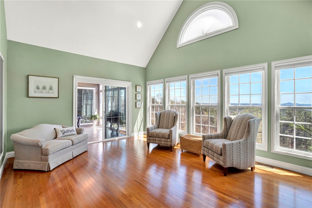 603 Tamassee Ridge Way Salem, SC 29676 - Photo 14 of 46 This living room features expansive windows framing a distant landscape, with soaring ceilings and hardwood floors.