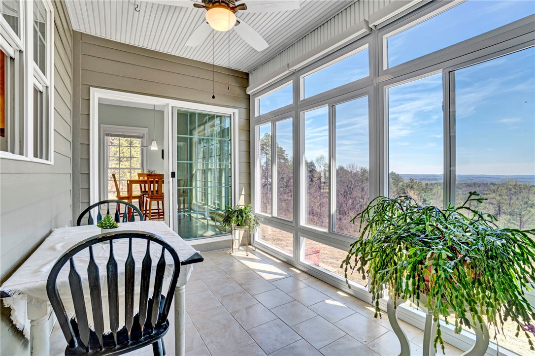 603 Tamassee Ridge Way Salem, SC 29676 - Photo 15 of 46 This sunroom offers an expansive vista, seamlessly blending indoor comfort with outdoor serenity.