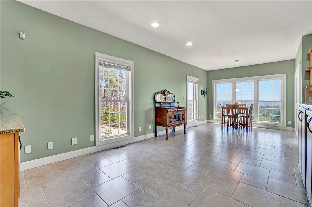 603 Tamassee Ridge Way Salem, SC 29676 - Photo 21 of 46 This expansive interior space features abundant natural light, offering a versatile layout for living and dining.