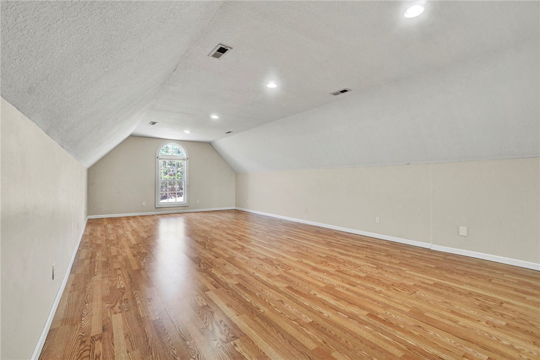 603 Tamassee Ridge Way Salem, SC 29676 - Photo 23 of 46 This expansive bonus room features vaulted ceilings and warm hardwood flooring, illuminated by recessed lighting.