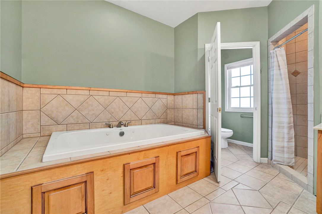 603 Tamassee Ridge Way Salem, SC 29676 - Photo 32 of 46 Relax and unwind in this inviting bathroom featuring a tiled tub and separate shower.