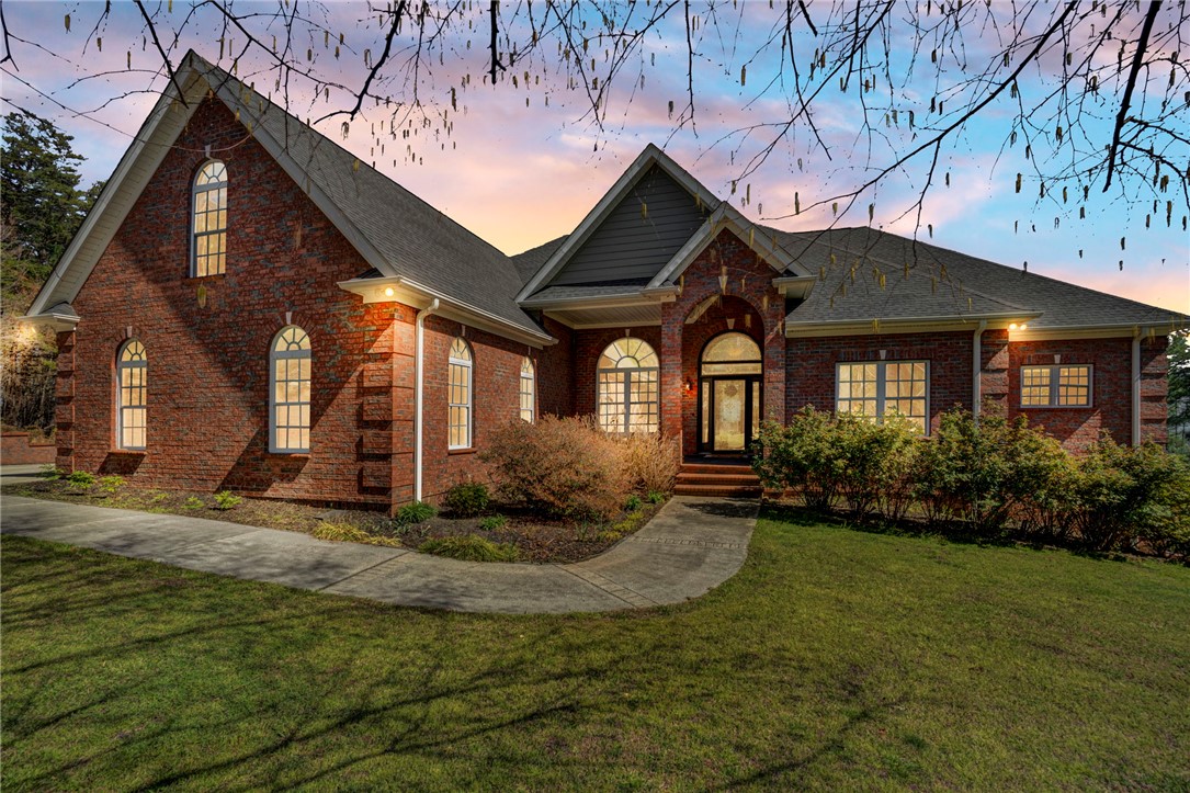 603 Tamassee Ridge Way Salem, SC 29676 - Photo 43 of 46 This classic brick residence features an inviting arched entryway, a manicured lawn, and lush landscaping.