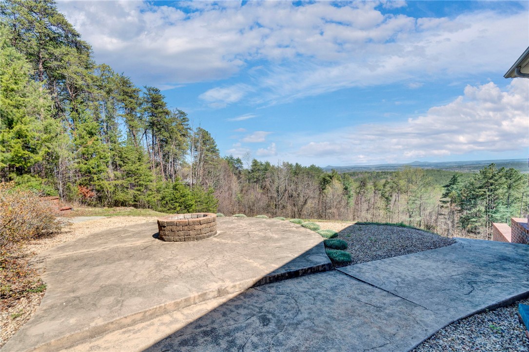 603 Tamassee Ridge Way Salem, SC 29676 - Photo 45 of 46 This spacious patio offers an idyllic setting for gatherings, complemented by a fire pit and panoramic views.