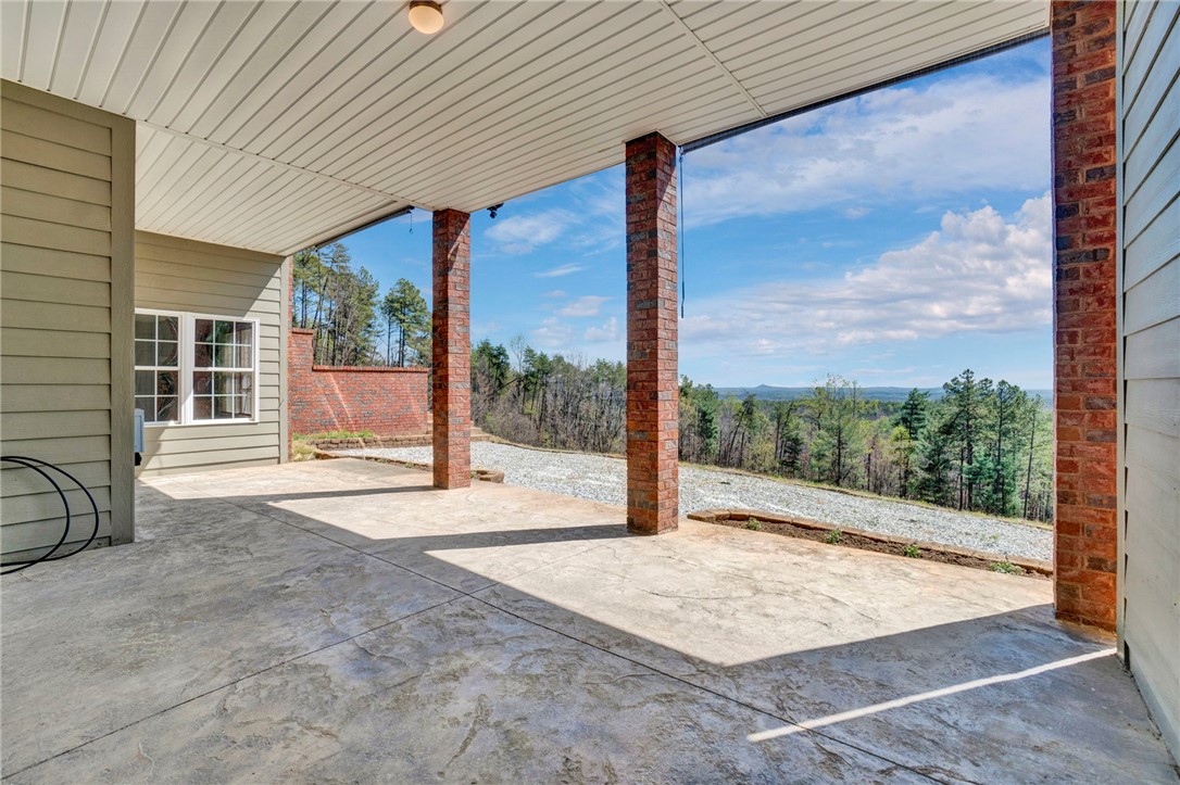 603 Tamassee Ridge Way Salem, SC 29676 - Photo 5 of 46 This covered patio offers serene mountain and tree views, perfect for peaceful outdoor enjoyment.