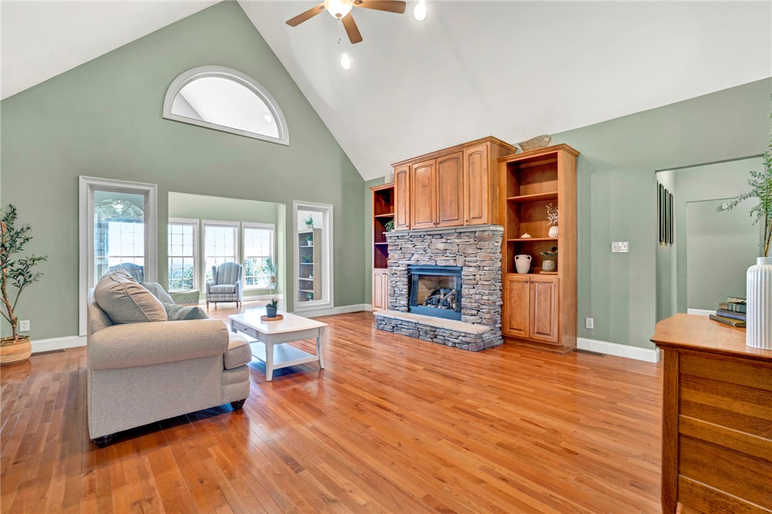 603 Tamassee Ridge Way Salem, SC 29676 - Photo 8 of 46 This airy living space features soaring ceilings and a captivating stone fireplace, creating an inviting atmosphere.
