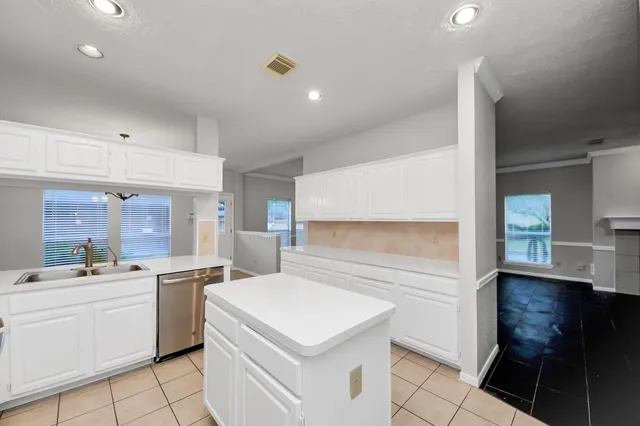a kitchen with a sink stove and cabinets
