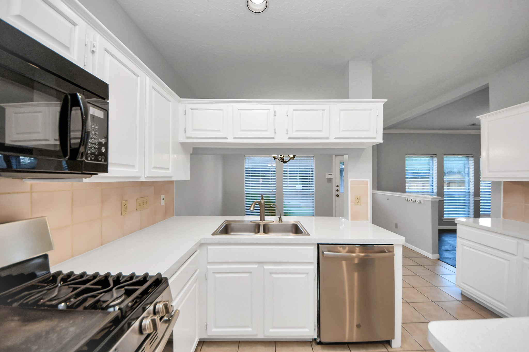 2102 Gemini Avenue Houston, TX 77058 - Photo 15 of 40 a kitchen with a sink stove and cabinets