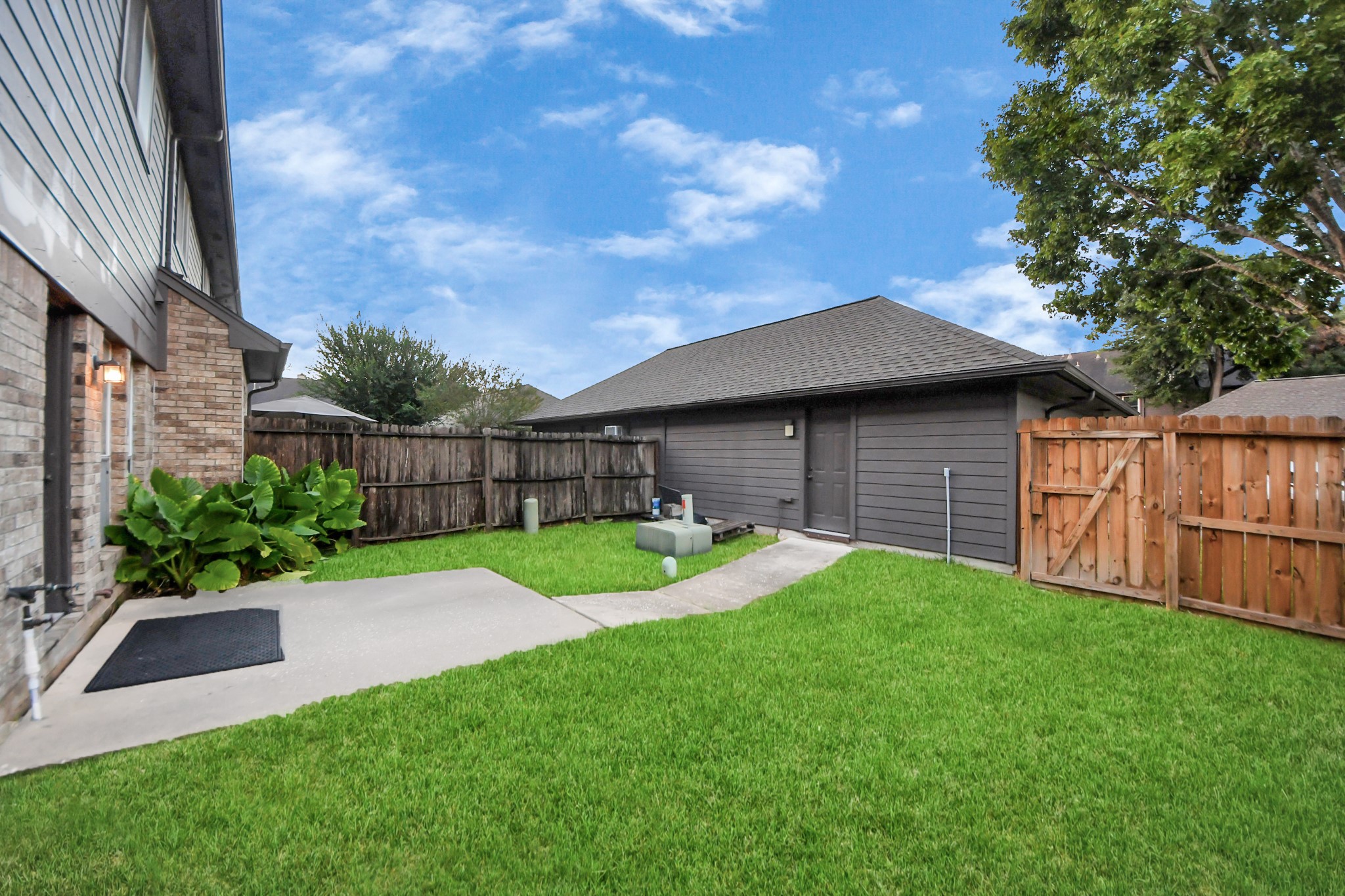 2102 Gemini Avenue Houston, TX 77058 - Photo 33 of 40 a view of backyard with table and chairs and wooden fence