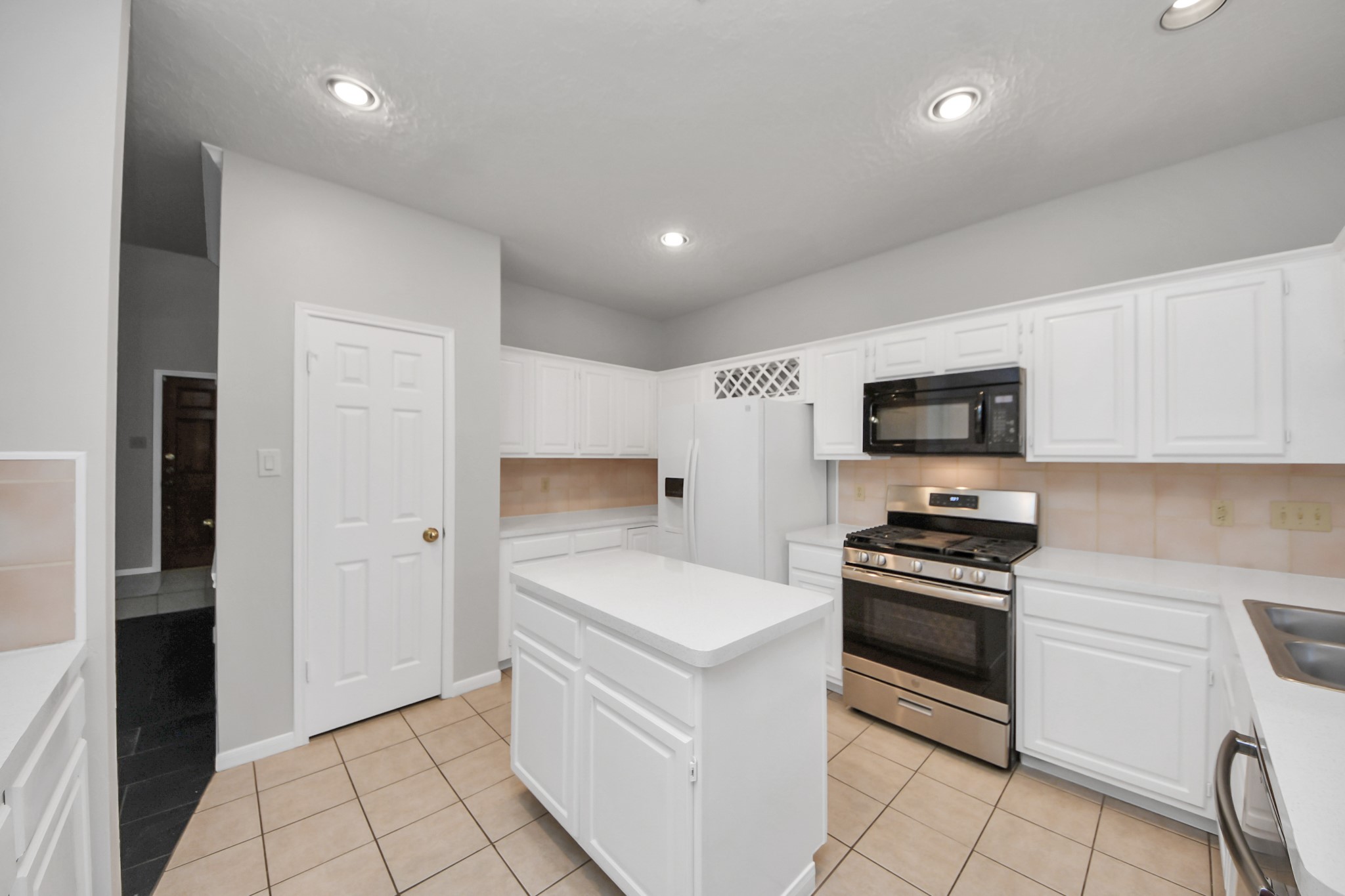 2102 Gemini Avenue Houston, TX 77058 - Photo 10 of 40 a kitchen with stainless steel appliances a stove microwave and refrigerator
