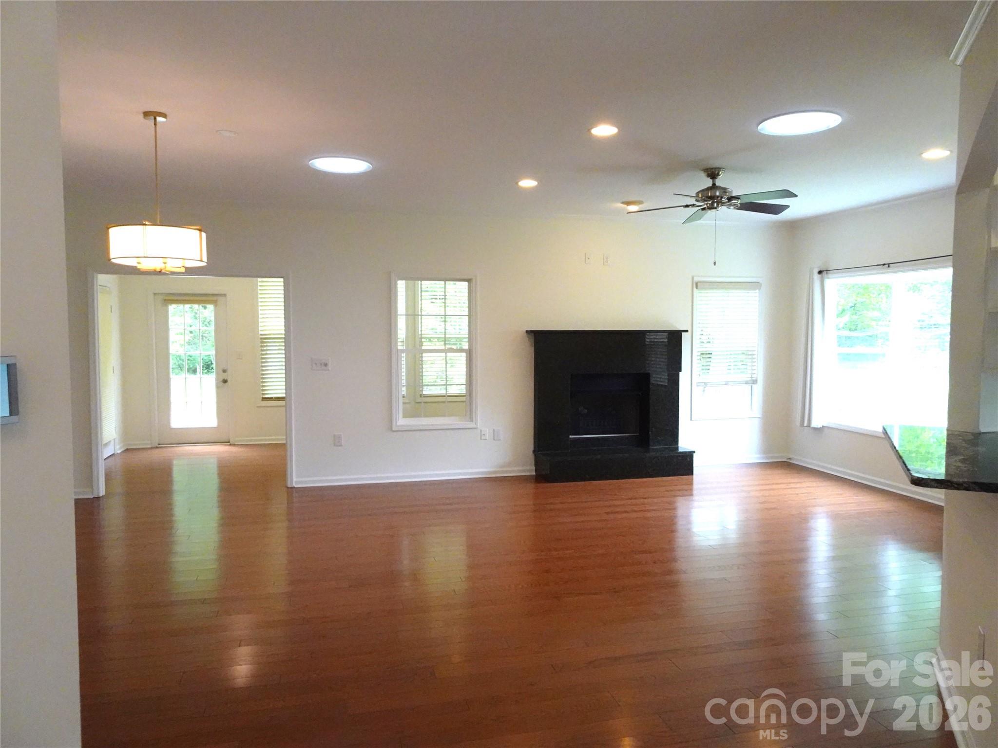 35 Sheffield Place Brevard, NC 28712 - Photo 13 of 38 an empty room with windows and fireplace