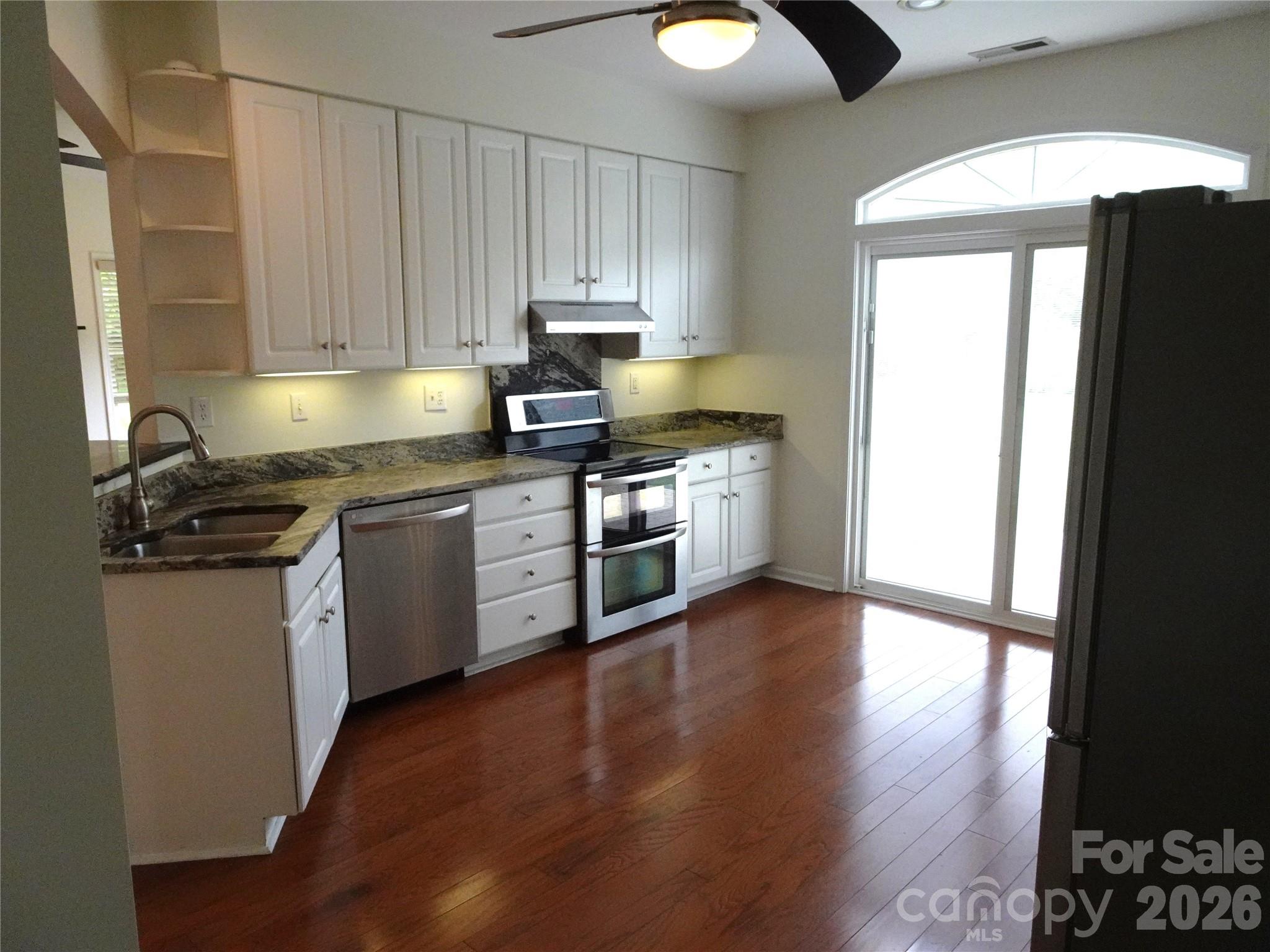 35 Sheffield Place Brevard, NC 28712 - Photo 15 of 38 a kitchen with stainless steel appliances a sink a stove a refrigerator and cabinets