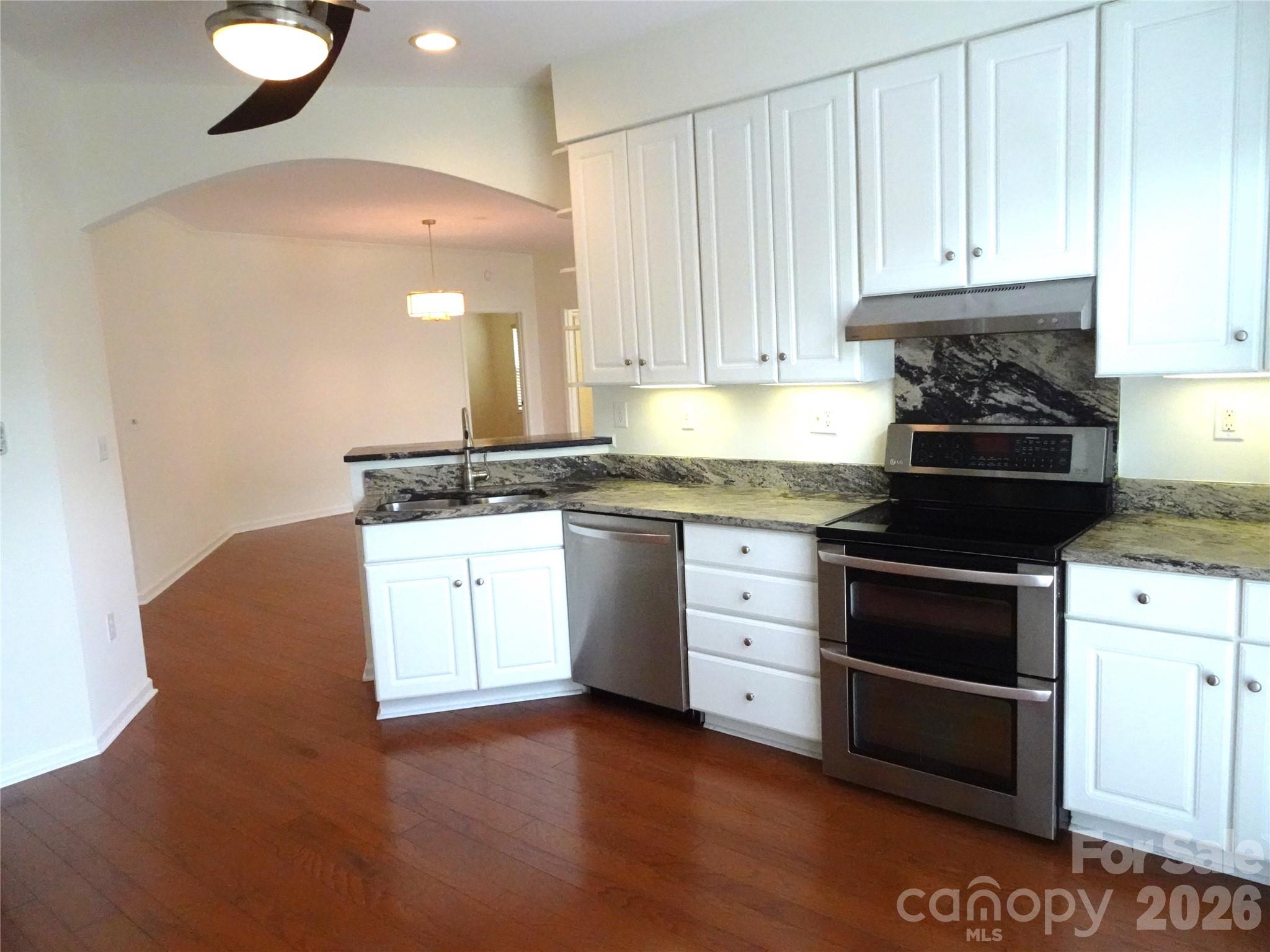 35 Sheffield Place Brevard, NC 28712 - Photo 18 of 38 a kitchen with granite countertop a stove a sink and a granite counter tops