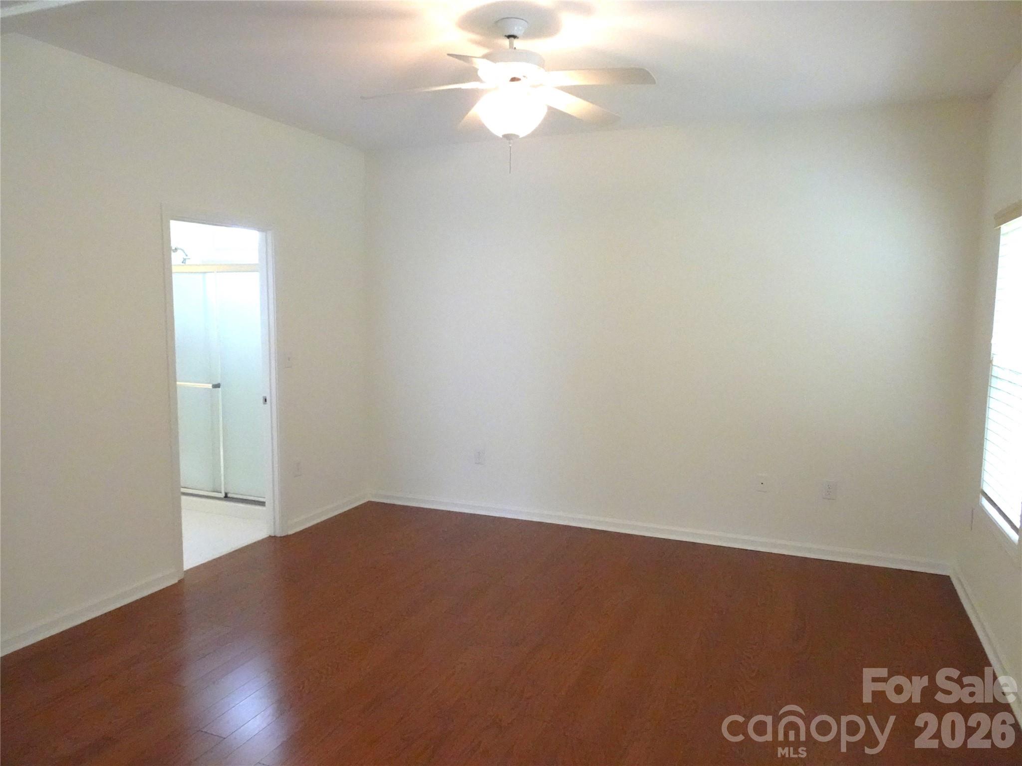 35 Sheffield Place Brevard, NC 28712 - Photo 20 of 38 an empty room with wooden floor and windows
