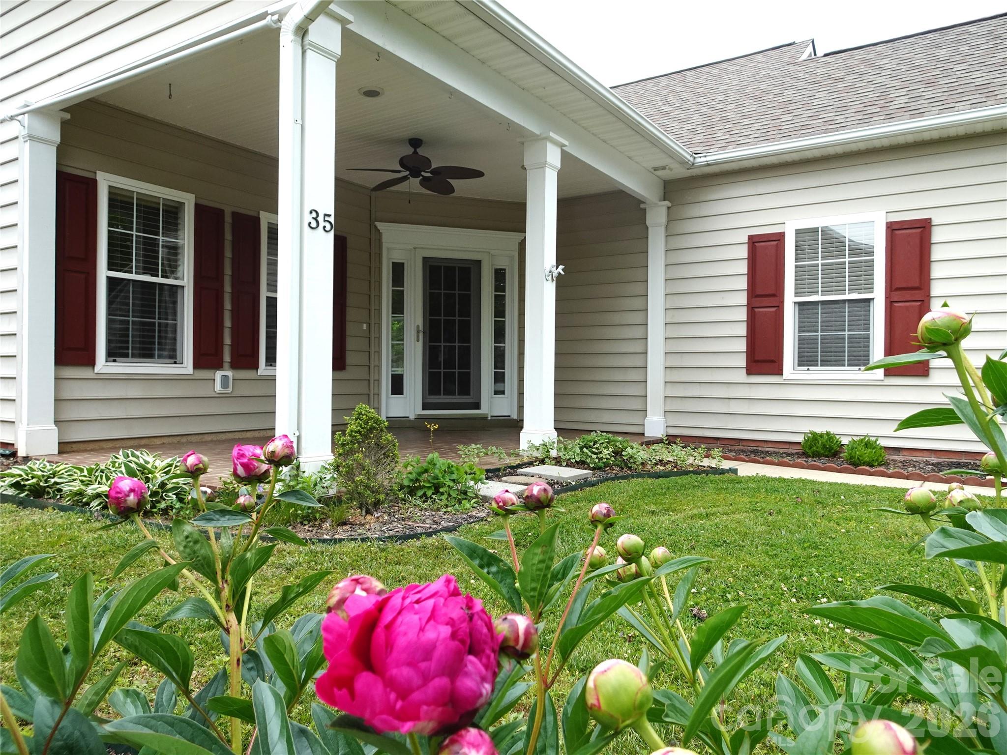 35 Sheffield Place Brevard, NC 28712 - Photo 2 of 38 a front view of house and yard with beautiful flowers
