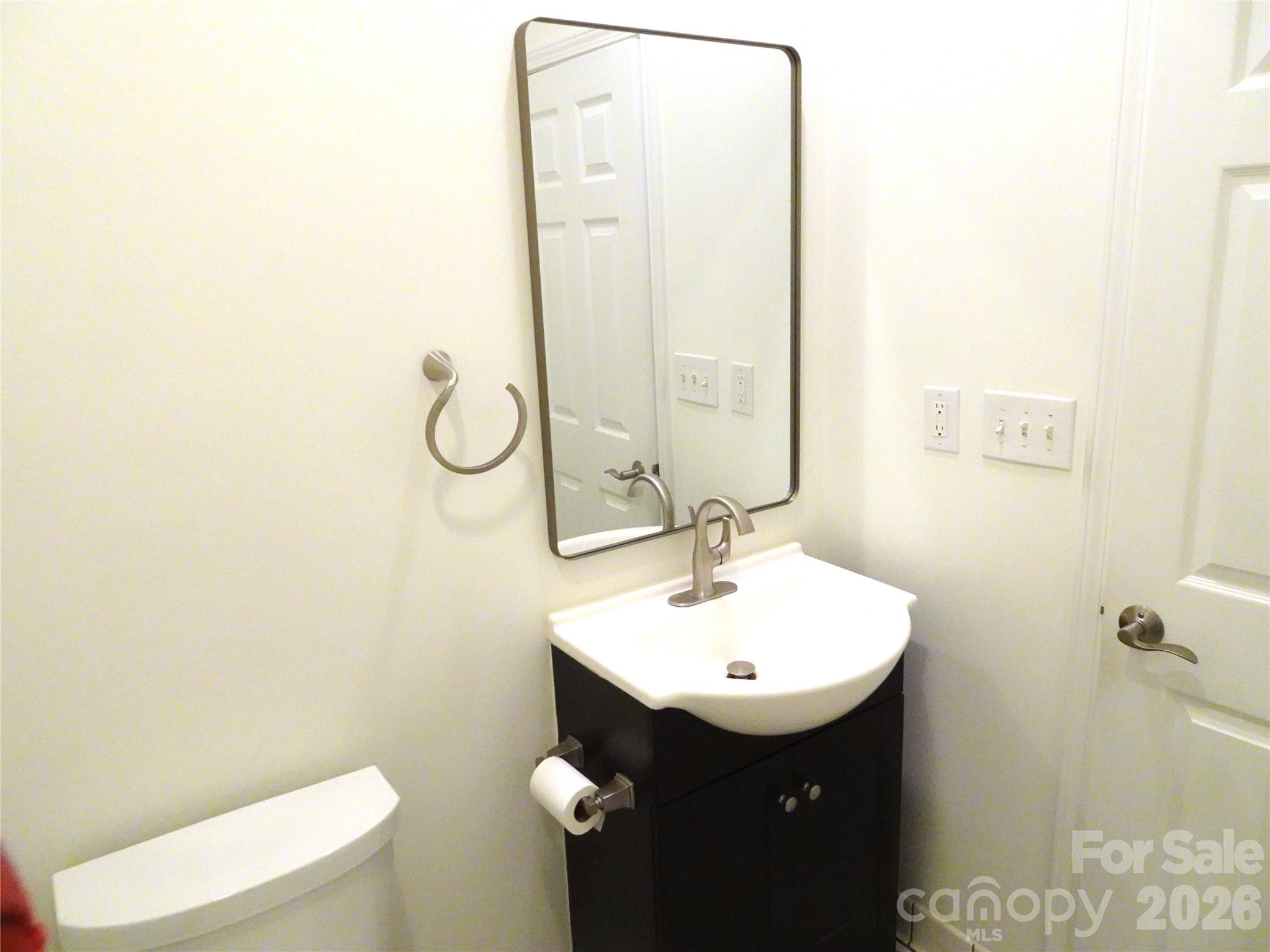 35 Sheffield Place Brevard, NC 28712 - Photo 28 of 38 a bathroom with a sink a toilet and mirror