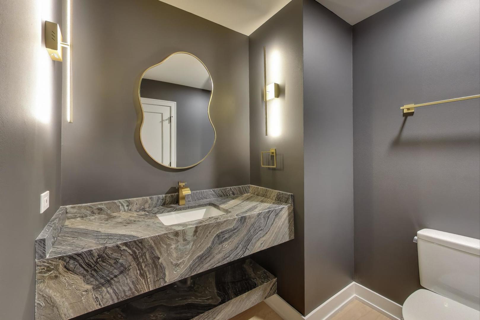 73 Augusta Drive Deerfield, IL 60015 - Photo 15 of 39 a bathroom with a granite countertop toilet sink and mirror