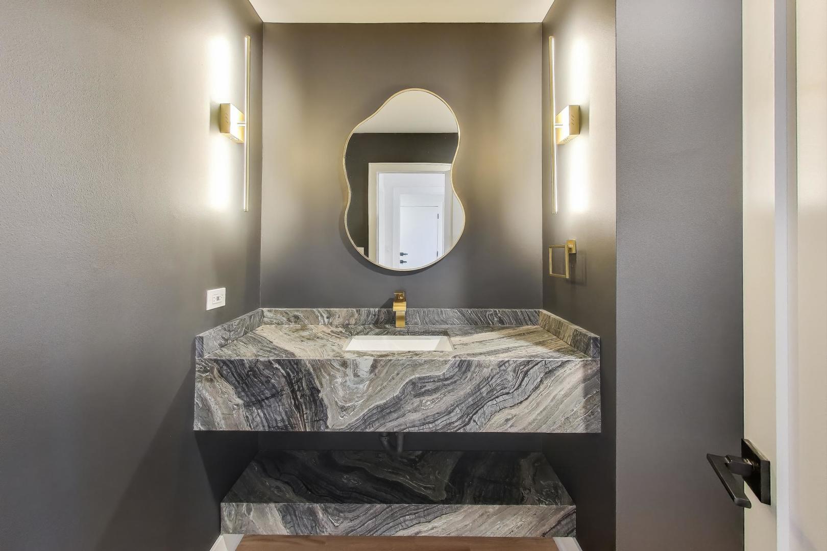 73 Augusta Drive Deerfield, IL 60015 - Photo 16 of 39 a bathroom with a granite countertop sink and a mirror