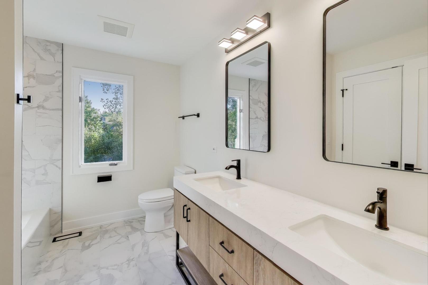 73 Augusta Drive Deerfield, IL 60015 - Photo 28 of 39 a bathroom with a double vanity sink toilet and mirror