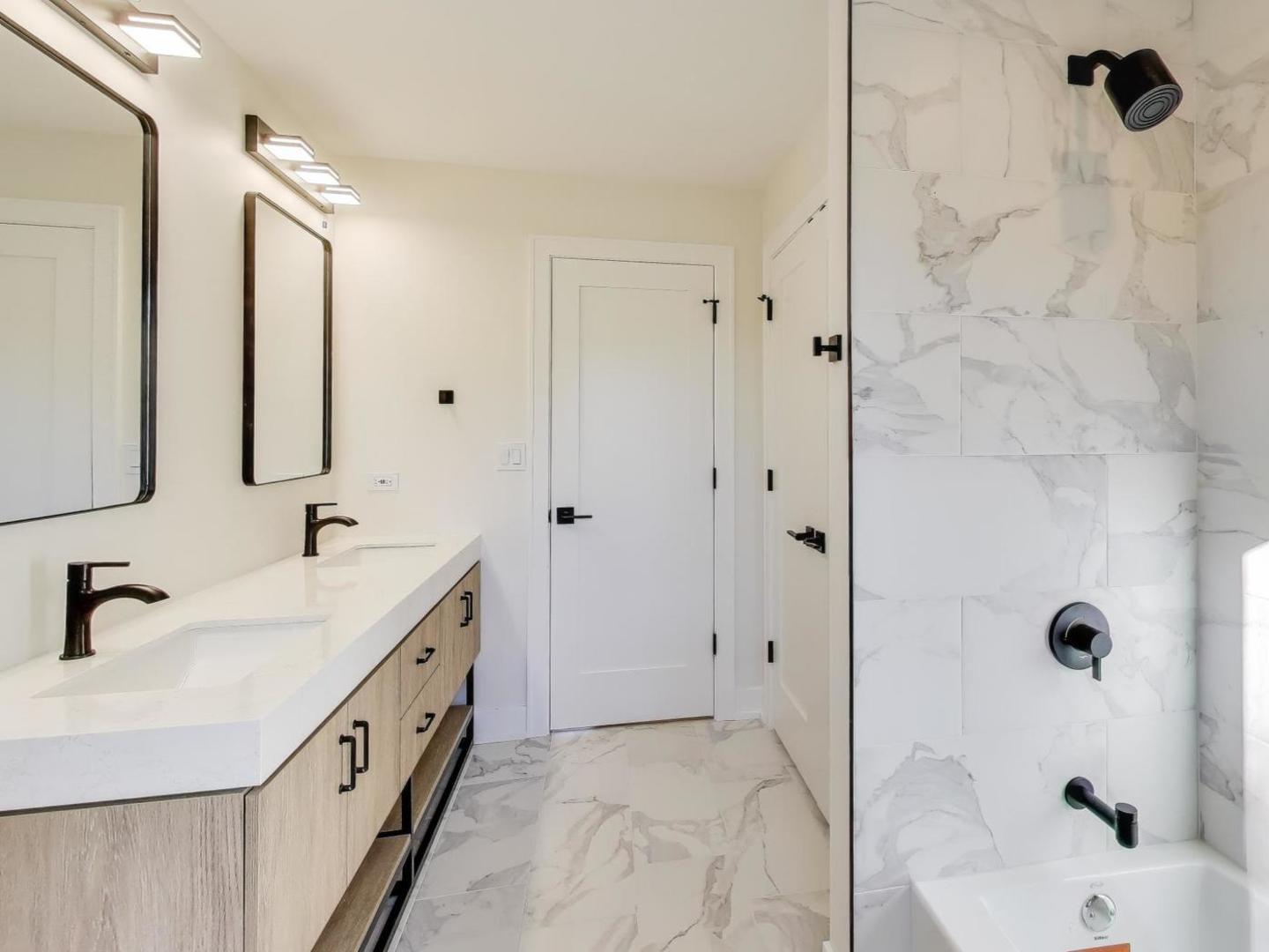 73 Augusta Drive Deerfield, IL 60015 - Photo 29 of 39 a bathroom with a tub sink double vanity and mirror