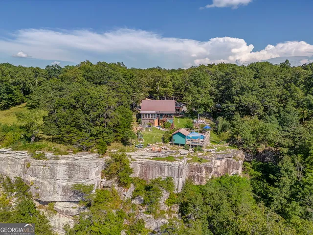 a aerial view of a house with a yard basket ball court and outdoor seating