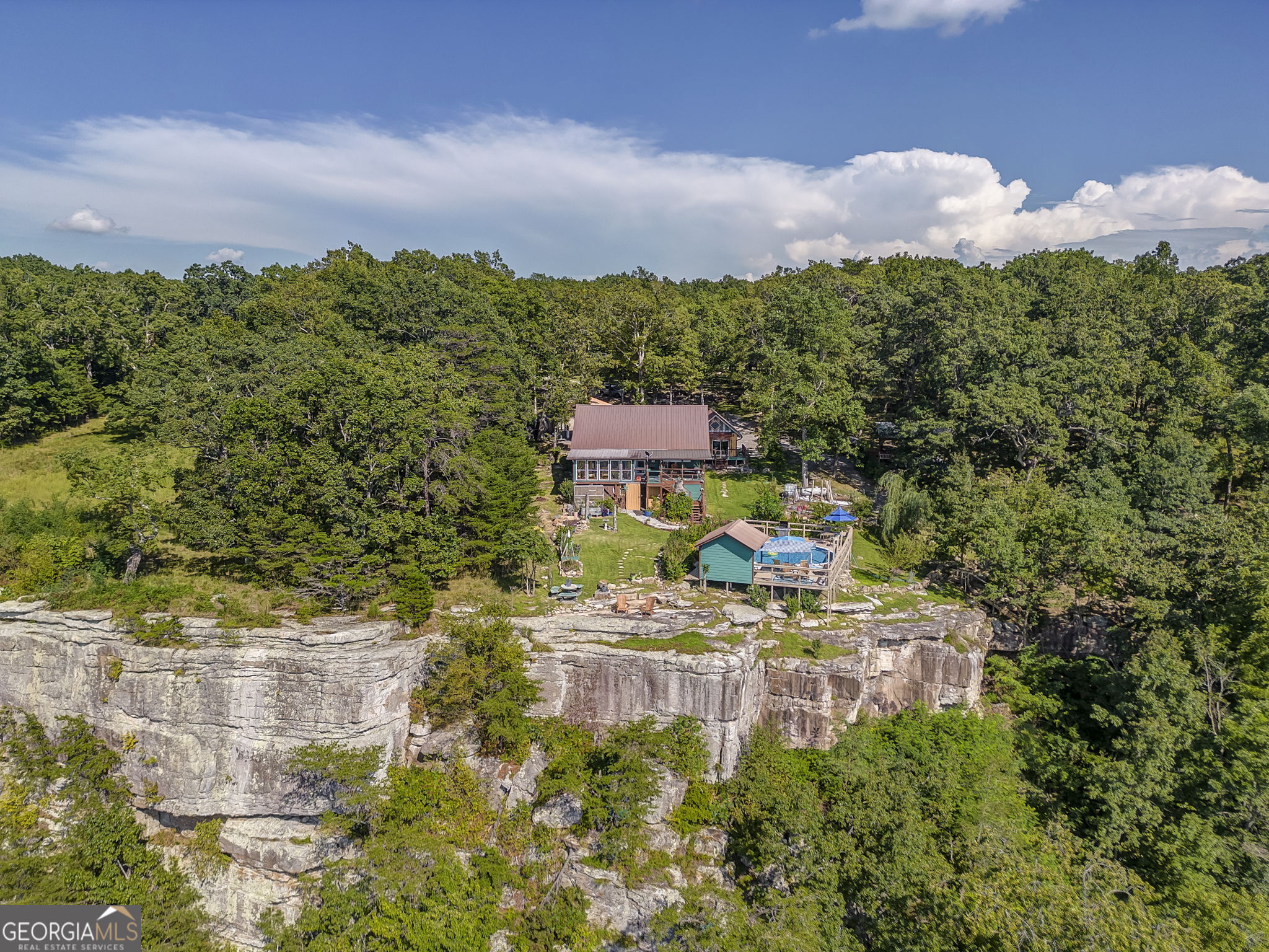 a aerial view of a house with a yard basket ball court and outdoor seating