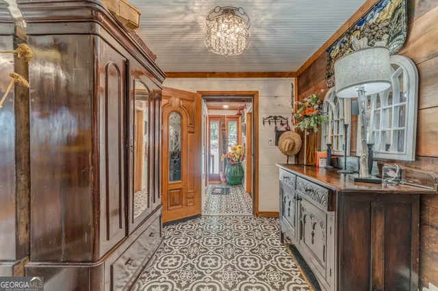 a dining hall with stainless steel appliances granite countertop a stove and cabinets