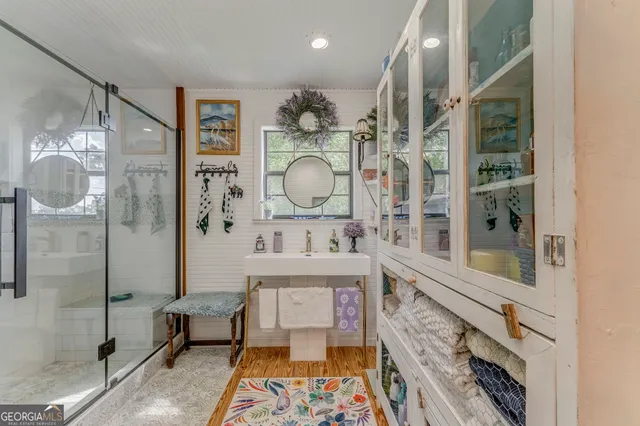 a living room with furniture and floor to ceiling windows