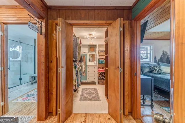 a view of a living room with furniture and floor to ceiling windows