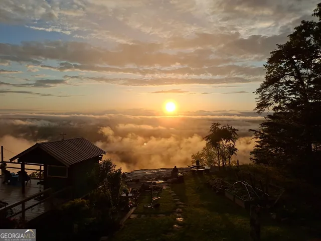 a living room with fireplace furniture and a large window