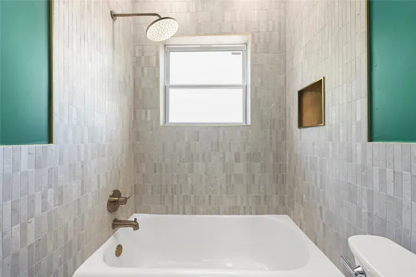 a bathroom with a bathtub and shower