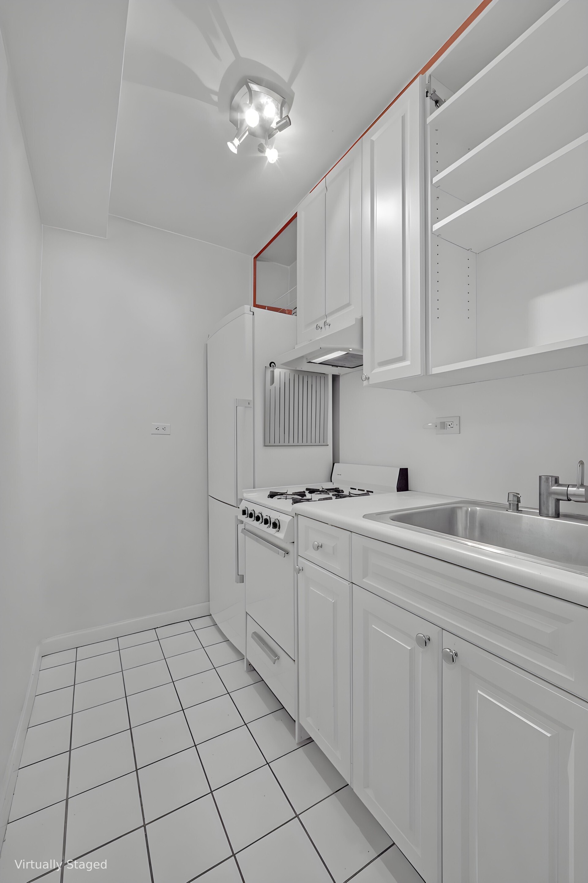 245 East 35th Street, Unit 9J Manhattan, NY 10016 - Photo 3 of 5 a kitchen with cabinets a sink and appliances