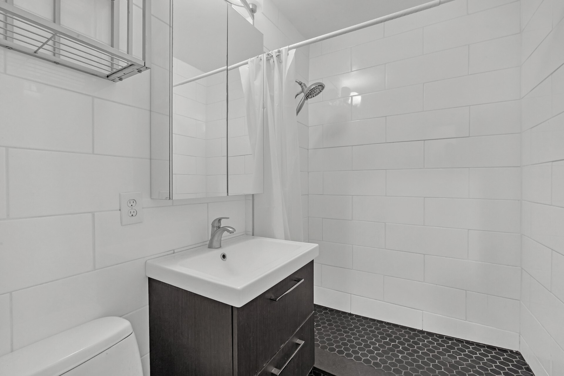 245 East 35th Street, Unit 9J Manhattan, NY 10016 - Photo 4 of 5 a bathroom with a sink a toilet and shower