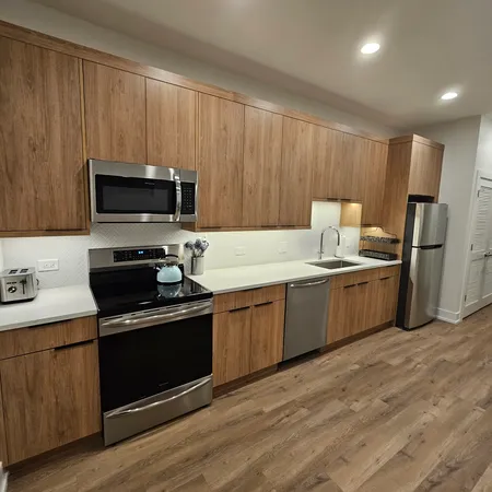 a kitchen with a sink appliances and cabinets