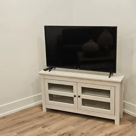 a living room with a fireplace and a wooden floor