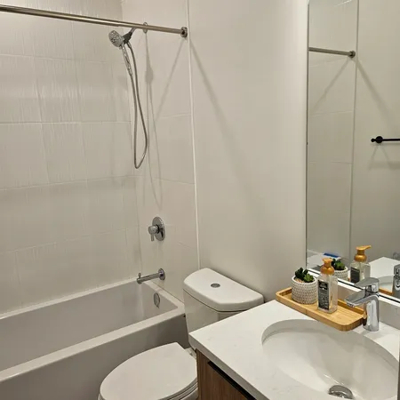 a bathroom with a sink toilet and shower