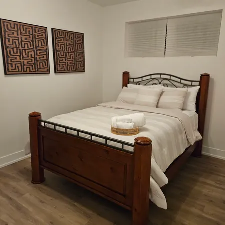 a bed sitting in a bedroom next to a cabinet