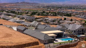1141 East Lost Ridge Drive Washington, UT 84780 - Photo 5 of 108 Residential property featuring a swimming pool with a surrounding patio, a covered outdoor area, and established landscaping