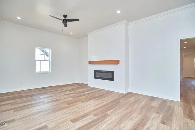 a view of empty room with wooden floor