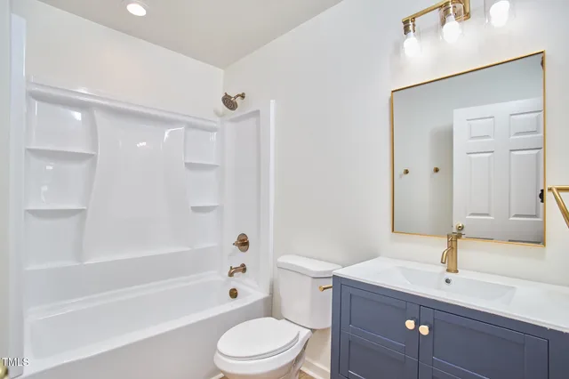 an empty room with wooden floor ceiling fan and windows
